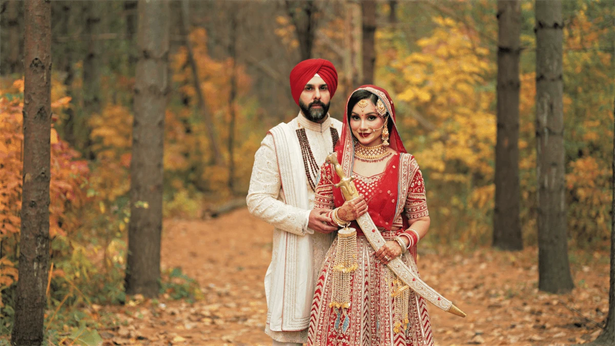 A Indian Sikh couple in traditional wedding attire poses in Claireville Conservation Area at Brampton for their Post Wedding photoshoot.