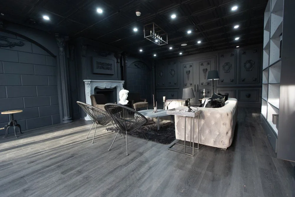 Cinematic indoor pre-wedding photography in the dark industrial suite at Vision Room Studio Brampton, featuring natural window light and moody textures.