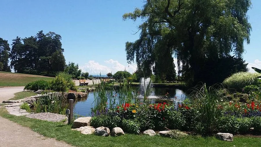 Elegant engagement portraits at Gairloch Gardens in Oakville, showcasing manicured lakeside gardens and stone pathways.