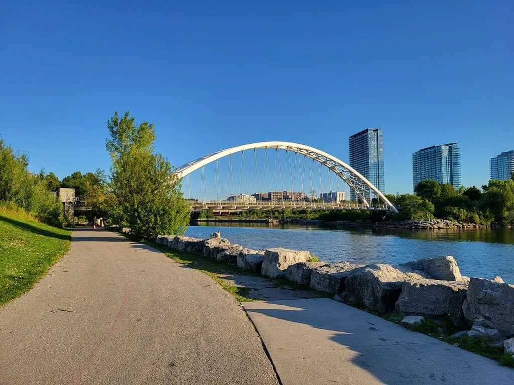 Pre-wedding shoot at the white geometric Humber Bay Arch Bridge in Toronto, featuring modern architectural lines.