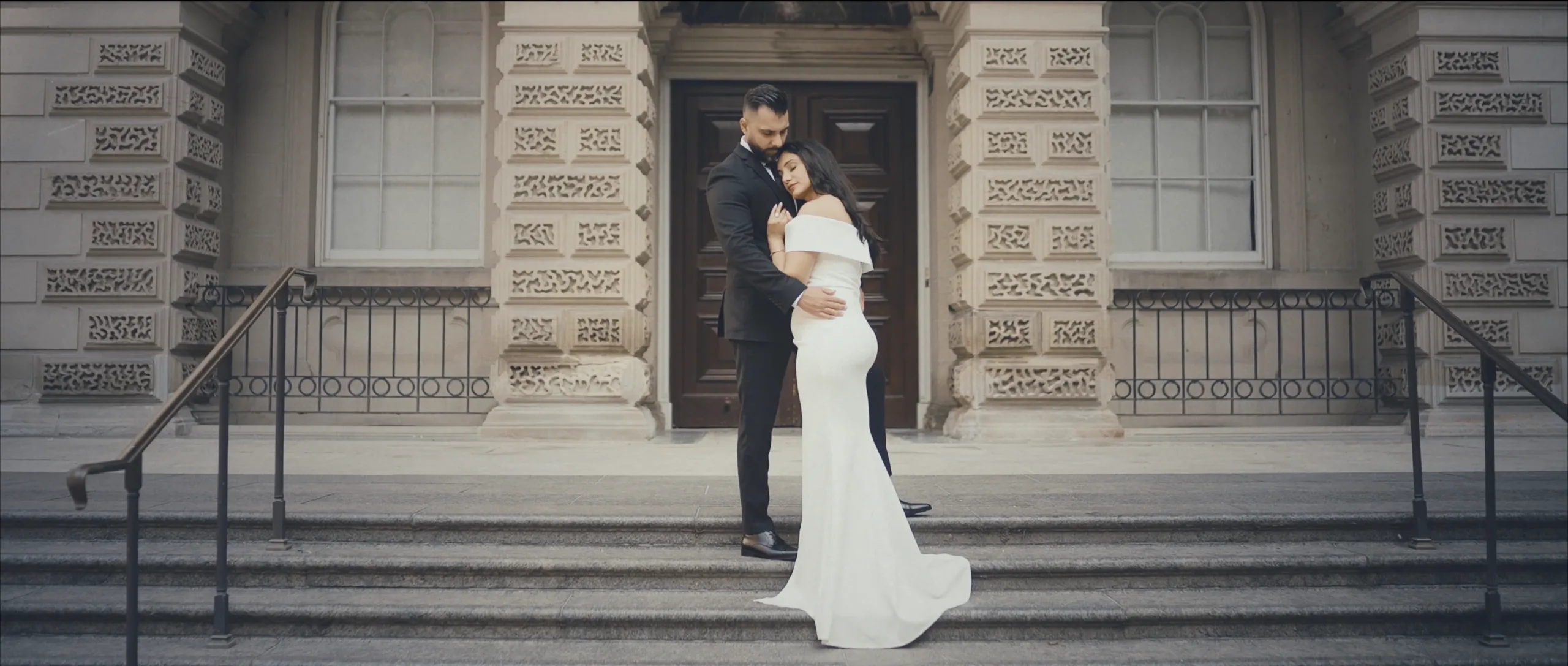 Editorial-style engagement photography at the heritage Osgoode Hall courthouse in Toronto, featuring grand stone architecture.
