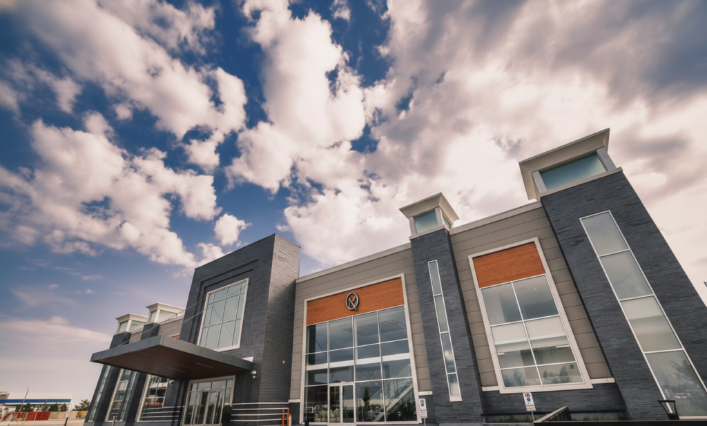 Bold modern industrial exterior of Queen's Manor Event Centre with outdoor terrace.